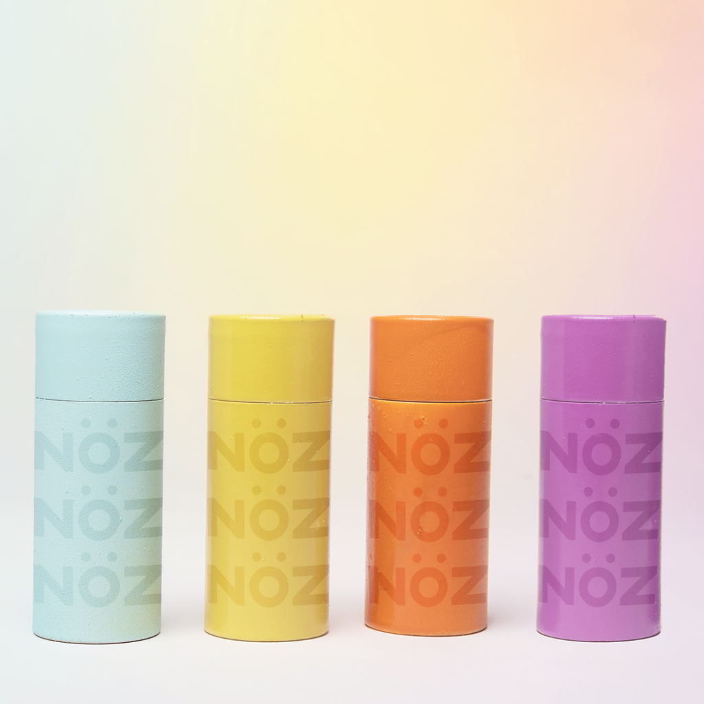 Front view of Nöz Color Variety Sunscreen. Blue, yellow, orange, purple