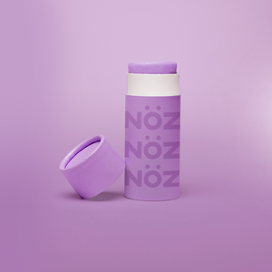 Front view of Nöz Color Variety Sunscreen. Purple with cap off